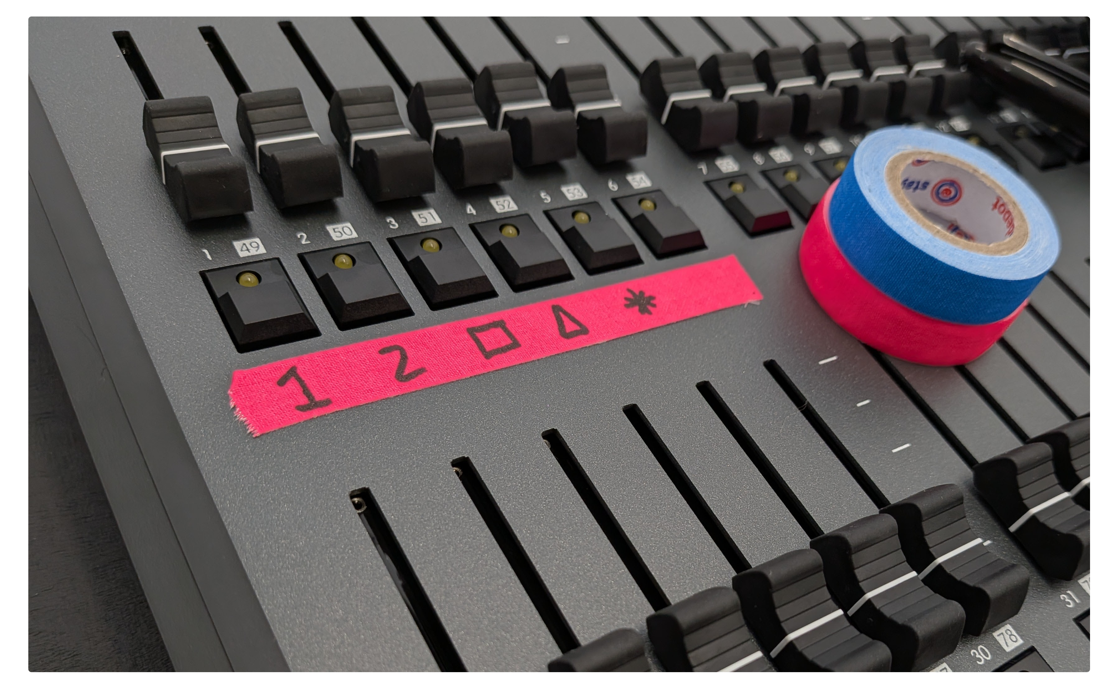 Our Stage Depot Mini Fluorescent gaffer tape being used to mark fader upon a lighting desk.
