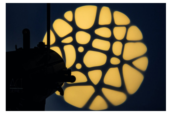 An Image of the Showtec profile projecting a gobo onto a wall