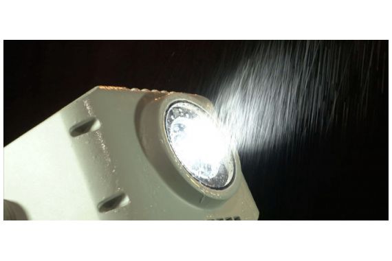 An Image of the Artecta gobo projector being used in the rain