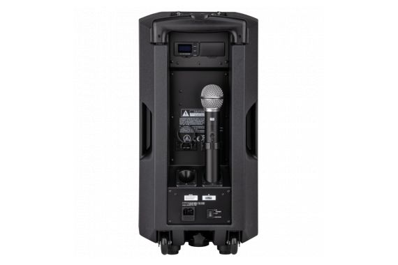 An Image of the back of the battery powered speaker showing the charging port and the clip for the included microphone